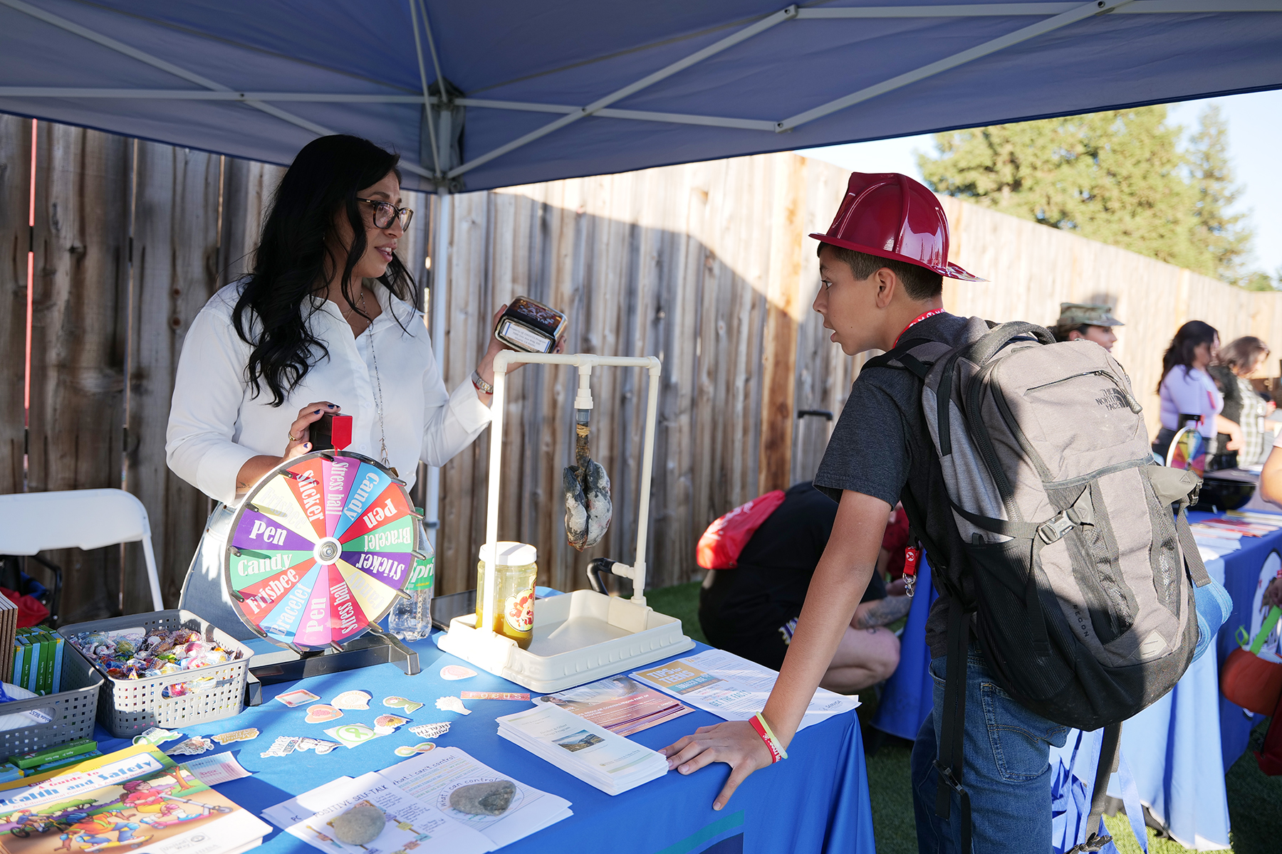youth at a prevention booth at Red Ribbon Week at Rawhide stadium