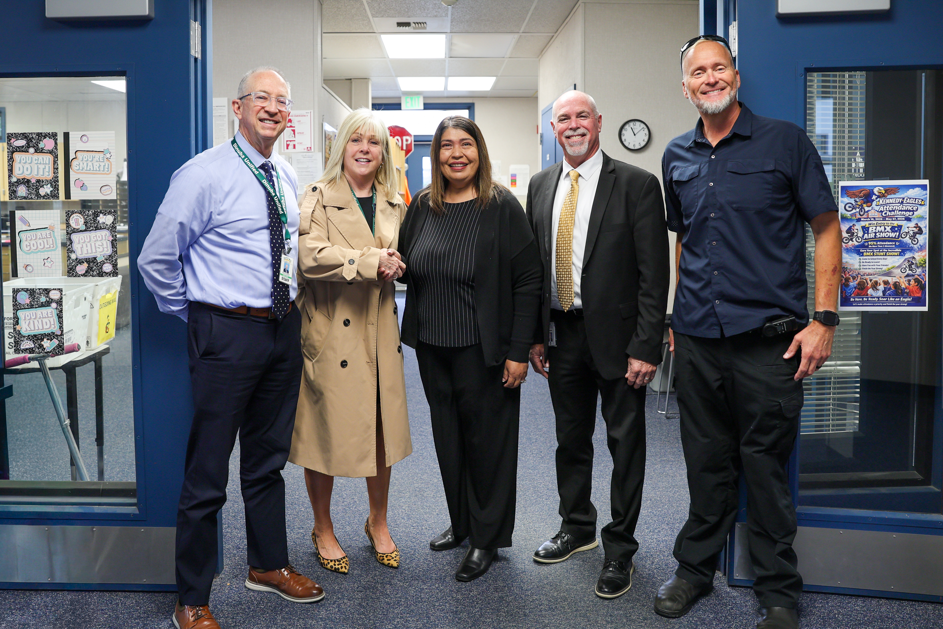 5 people pose for photo