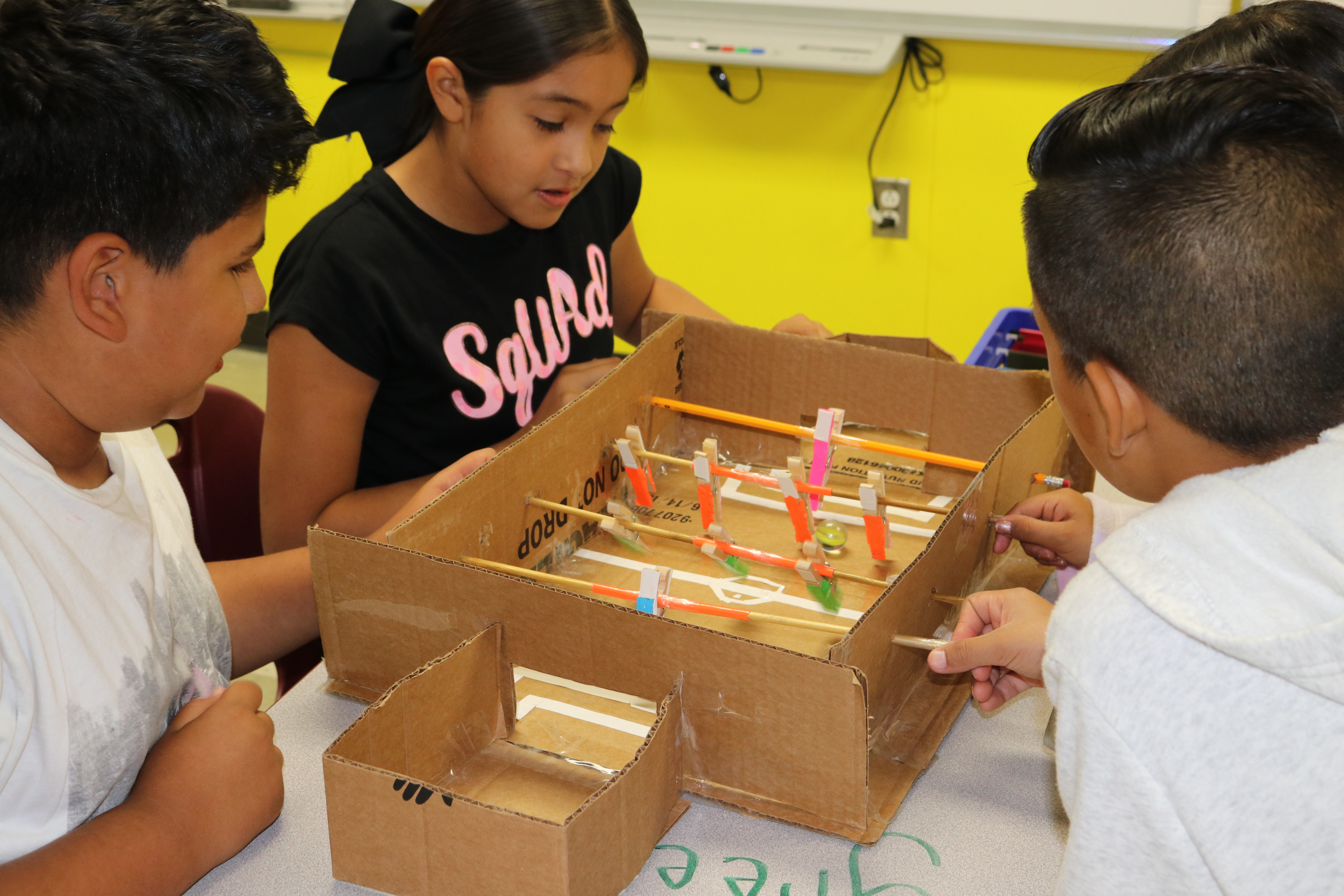 Children playing with a cardboard game