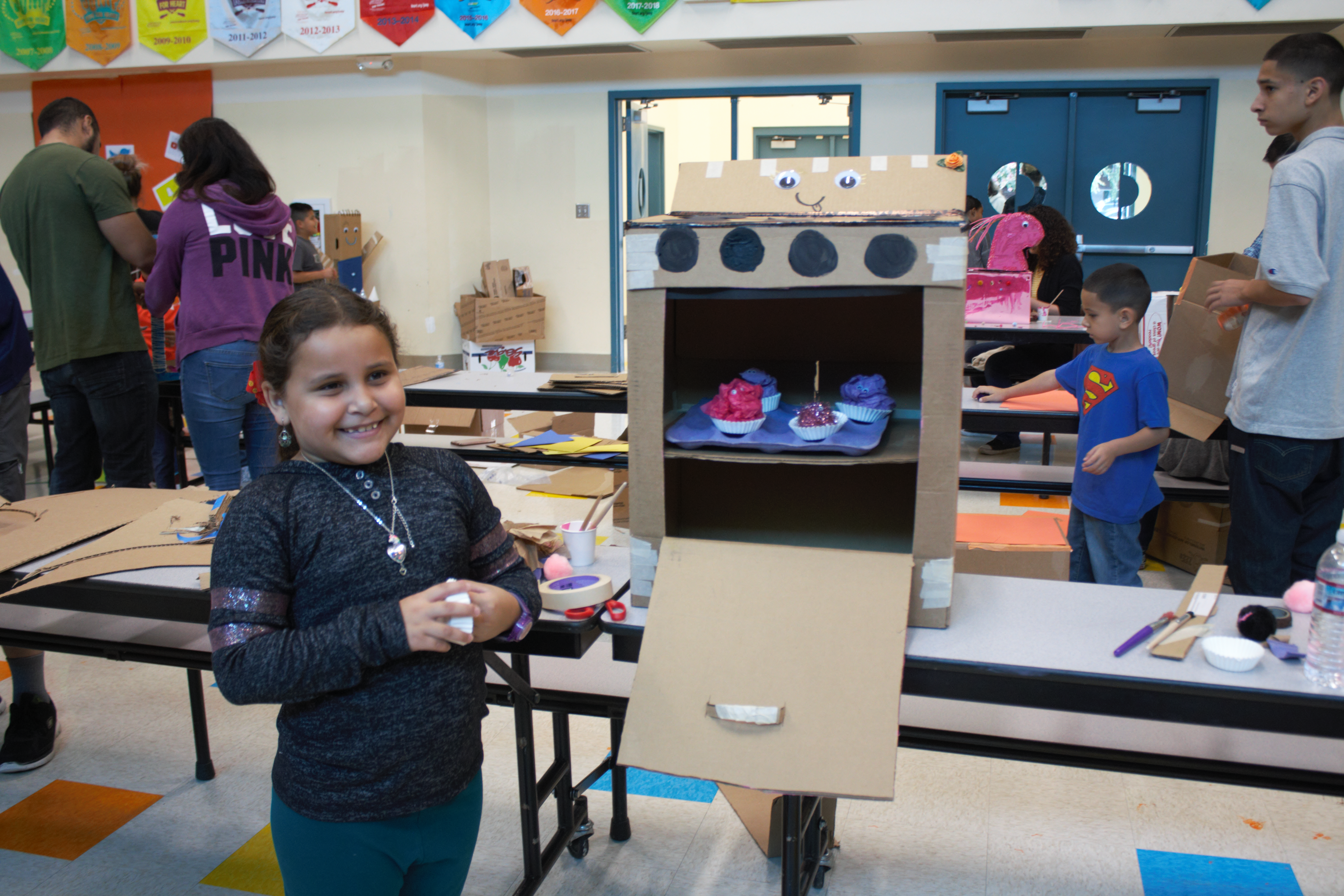 Little girl with cardboard oven creation