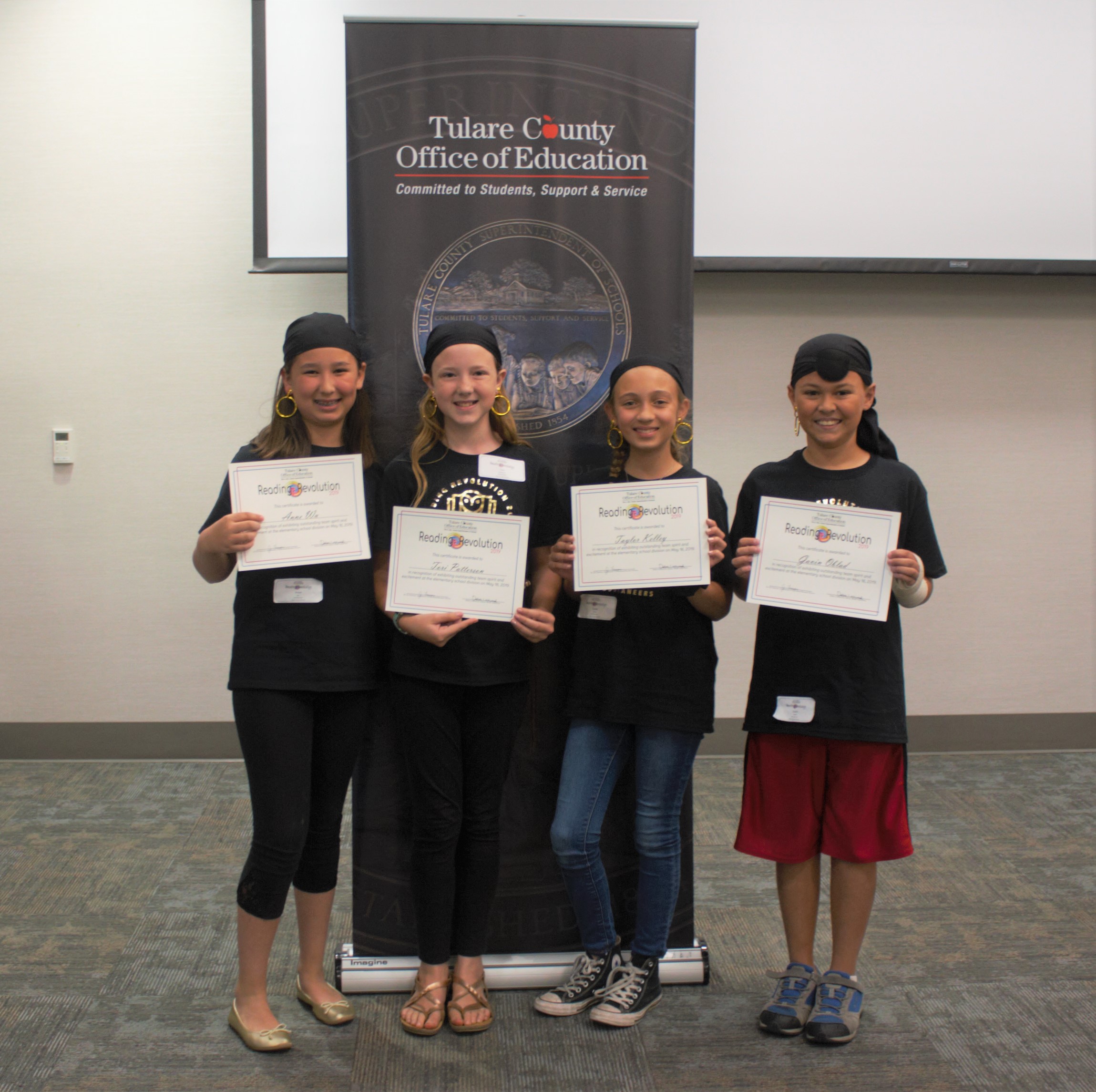 Reading Revolution students holding up their certificates